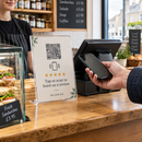 Tap and scan review stand being tapped with a phone at a till