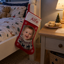 Personalised Christmas stocking: a personalised red-bordered Christmas stocking printed with the name 'Alfie' and a photo of a baby hanging on the end of a child's bed on Christmas Eve
