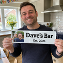 Personalised metal sign, held up proudly by a smiling man in a UK kitchen on his birthday