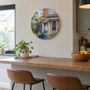 Personalised glass photo clock, hanging on a kitchen wall above a breakfast bar with stools