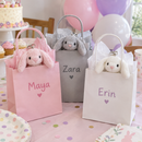 Personalised mini bunny keyrings in pink, grey and white printed with 'Maya', 'Zara' and 'Erin' peeking out of party bags
