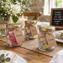Personalised sweet jars used as wedding favours on a table