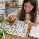 Kiss-cut sticker sheets being used at a kitchen table