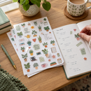 Kiss-cut sticker sheets decorating a planner