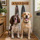 Two dogs waiting under a personalised wooden dog lead hook