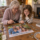 Personalised photo jigsaw: a grandmother and granddaughter doing a personalised A4 photo jigsaw of a family photo with the words 'Happy Birthday Nanna' on a coffee table in a cosy UK living room