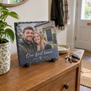 Personalised photo slate plaque with a photo and the message Our first home on a hallway table