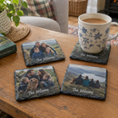 Personalised photo slate coasters with a family photo and the name The Wilsons with a mug of tea on a coffee table