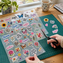 UV DTF gang sheet being cut on a craft mat