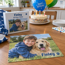 Personalised kids jigsaw: a birthday present opened on a kitchen table showing a personalised 30 piece kids jigsaw with a photo of a boy and his dog and the name 'Finley'