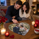 Personalised heart jigsaw: a couple on a sofa on Valentine's evening fitting the last piece into a personalised heart-shaped photo jigsaw printed with their wedding photo and the names 'Dan & Chloe'
