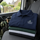 Logo polo shirt folded in a work van