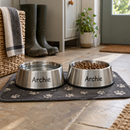 Personalised stainless steel pet bowls on a dog bowl mat