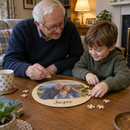 Personalised wooden jigsaw: grandad and grandson finishing a personalised round wooden jigsaw of a family photo with the name 'Jasper' on a living room coffee table in a British home