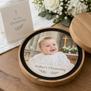 Personalised wooden jigsaw: a personalised round wooden jigsaw in its presentation case with a christening photo and the text 'Arthur's Christening' on a table beside a christening card