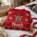 Matching family Christmas jumper with the name Noah folded with wrapping paper