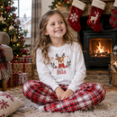 Personalised Christmas pyjamas with the name Isla worn on Christmas Eve by the fireplace