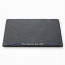Personalised slate serving and cheese board with the name The Taylors on a white background