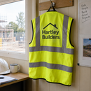 Hi-vis vest with logo hanging in a site cabin