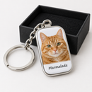 Personalised pet photo keyring: a personalised silver metal oblong keyring with a gloss white insert printed with a close-up photo of a ginger cat and the name 'Marmalade' underneath