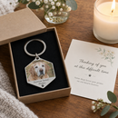 Personalised pet photo keyring: an open gift box on a table with a personalised hexagonal metal pet photo keyring showing an elderly golden labrador and the text 'Forever loved - Honey'