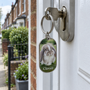 Personalised pet photo keyring: oblong metal keyring with a lop-eared rabbit photo and the name 'Clover' hanging from a front door key