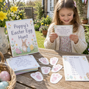 Personalised Easter egg hunt kit with the name Poppy a child reading a clue on Easter morning