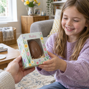 Personalised Easter egg box with the name Ruby being handed to a child