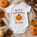 My first Halloween baby grow with the name Archie with mini pumpkins and autumn leaves