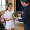 Personalised award plaque, being presented at a junior football club awards evening in a UK village hall
