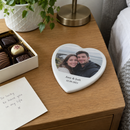 Personalised heart photo tile, on a bedside table with a small box of chocolates and a card