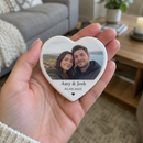 Personalised heart photo tile, held in the palm of a woman's hand, close up