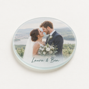 Personalised glass photo coaster printed with a wedding photo and the name Laura & Ben, on a plain background