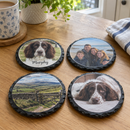 Personalised slate photo coaster, a set of four with different family photos arranged on a kitchen table