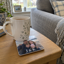Personalised wooden photo coaster, with a mug on it beside a sofa on a side table in a UK living room