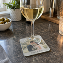 Personalised glass photo coaster, under a glass of wine on a home bar counter