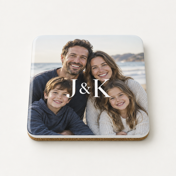 Personalised wooden photo coaster printed with a monogram J & K over a family photo, on a plain background