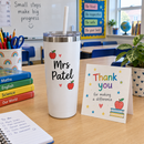 White name tumbler with straw as a teacher gift on a classroom desk