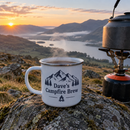Enamel mug with a name on a rock by a camping stove