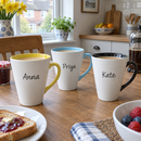 Three name latte mugs with coloured insides on a breakfast table