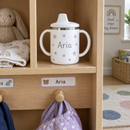 Name sippy cup on a nursery shelf