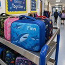 Blue name lunch bag on a school lunch trolley