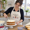 Cream name apron while icing a cake