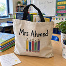 Teacher name tote bag full of books
