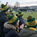 Group of fans wearing matching custom knitted football bobble hats