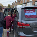 Family car on matchday with a custom football car flag on the rear window