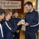 Coach receiving a personalised thank you mug from young players at a presentation
