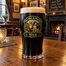 Tulip pint of stout with a colourful Fox & Hound name print on a pub table