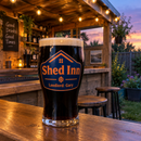 Colour-printed tulip pint glass on a garden bar shed counter at dusk
