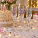 Three colour-printed flutes with names on a birthday table with cake